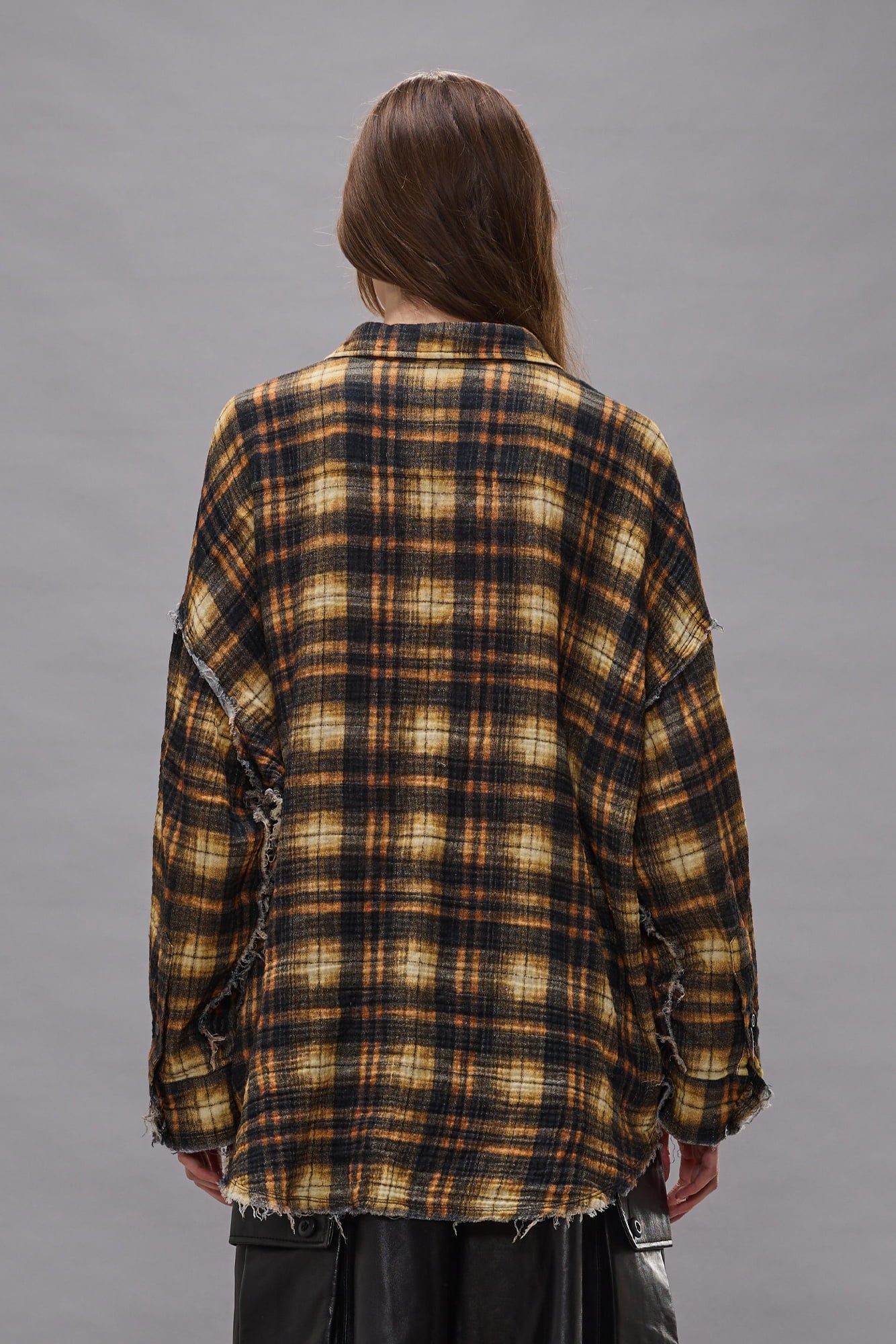 Brown, black, and cream plaid button-up shirt with shredded seams and distressed edges on sleeves.