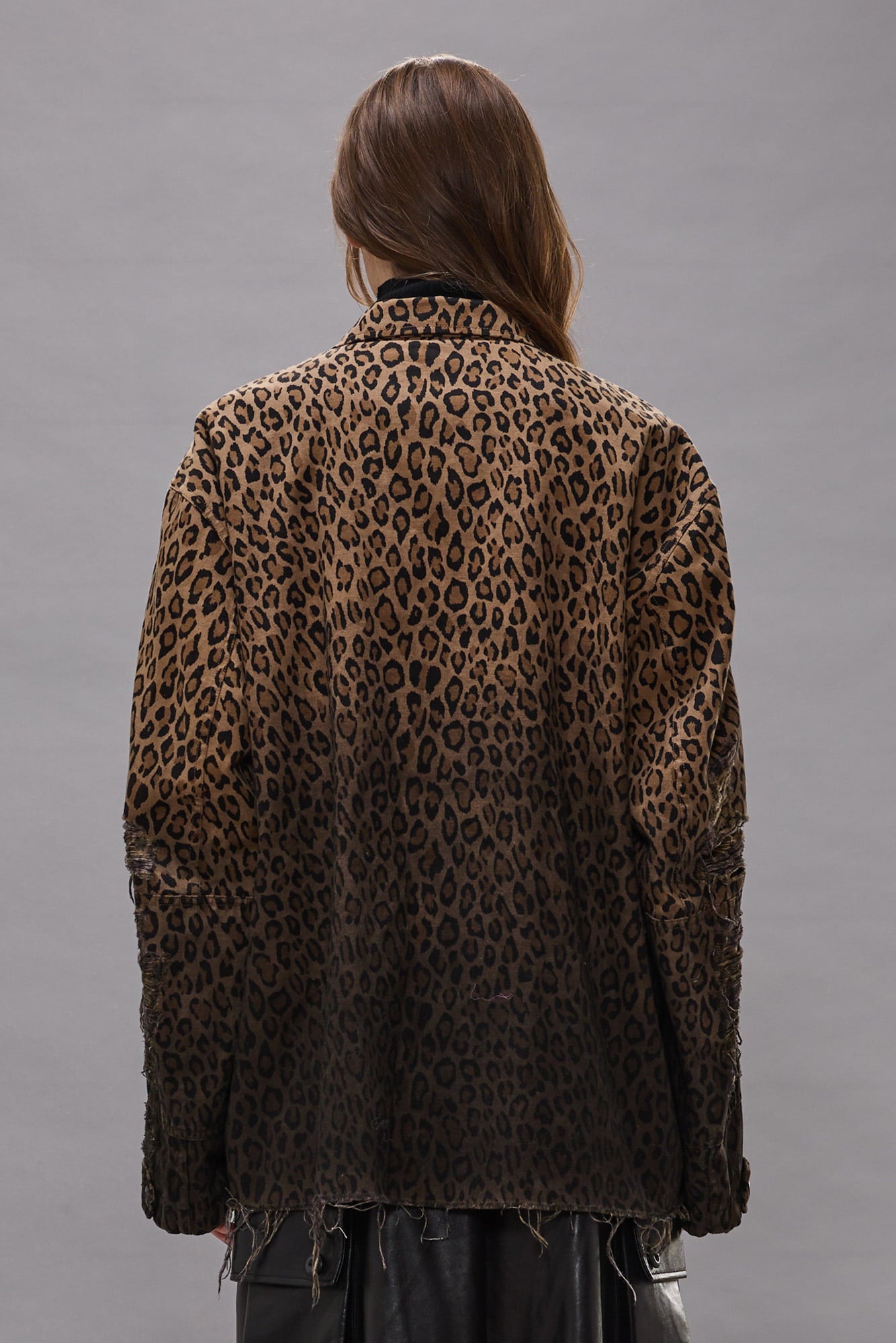 Brown leopard print jacket with distressed edges and shredded detailing on sleeves and hem, shown from back.