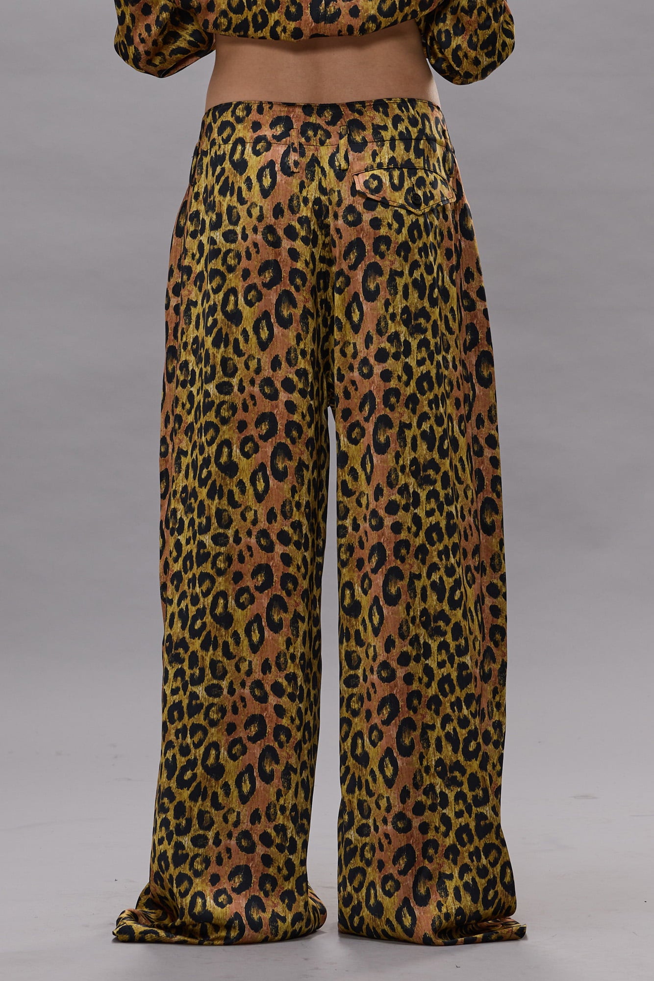 Wide-leg pants with leopard print in brown, tan, and black with front pleats.