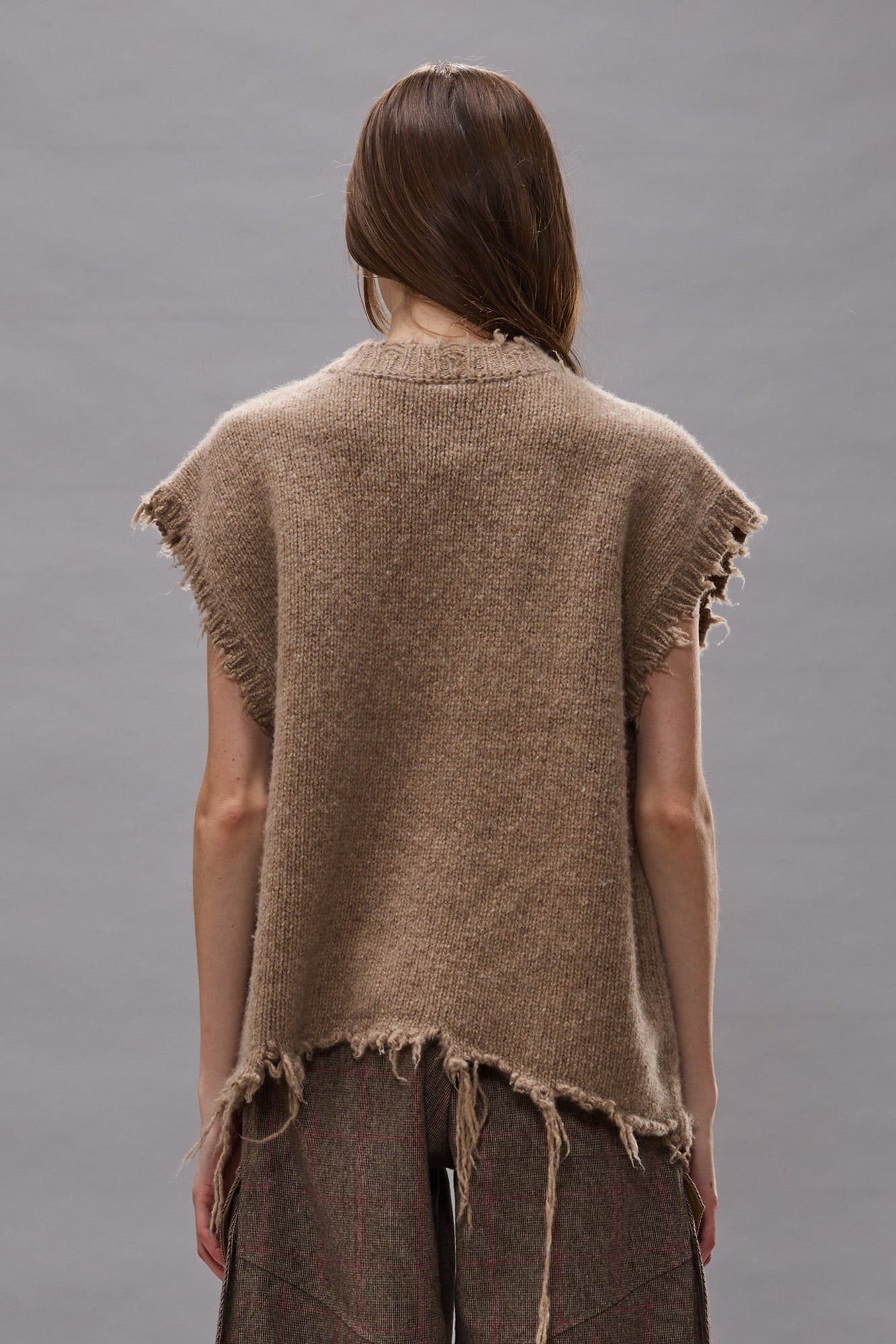 Tan and brown leopard print knit sweater vest with distressed edges and short sleeves, shown from back.