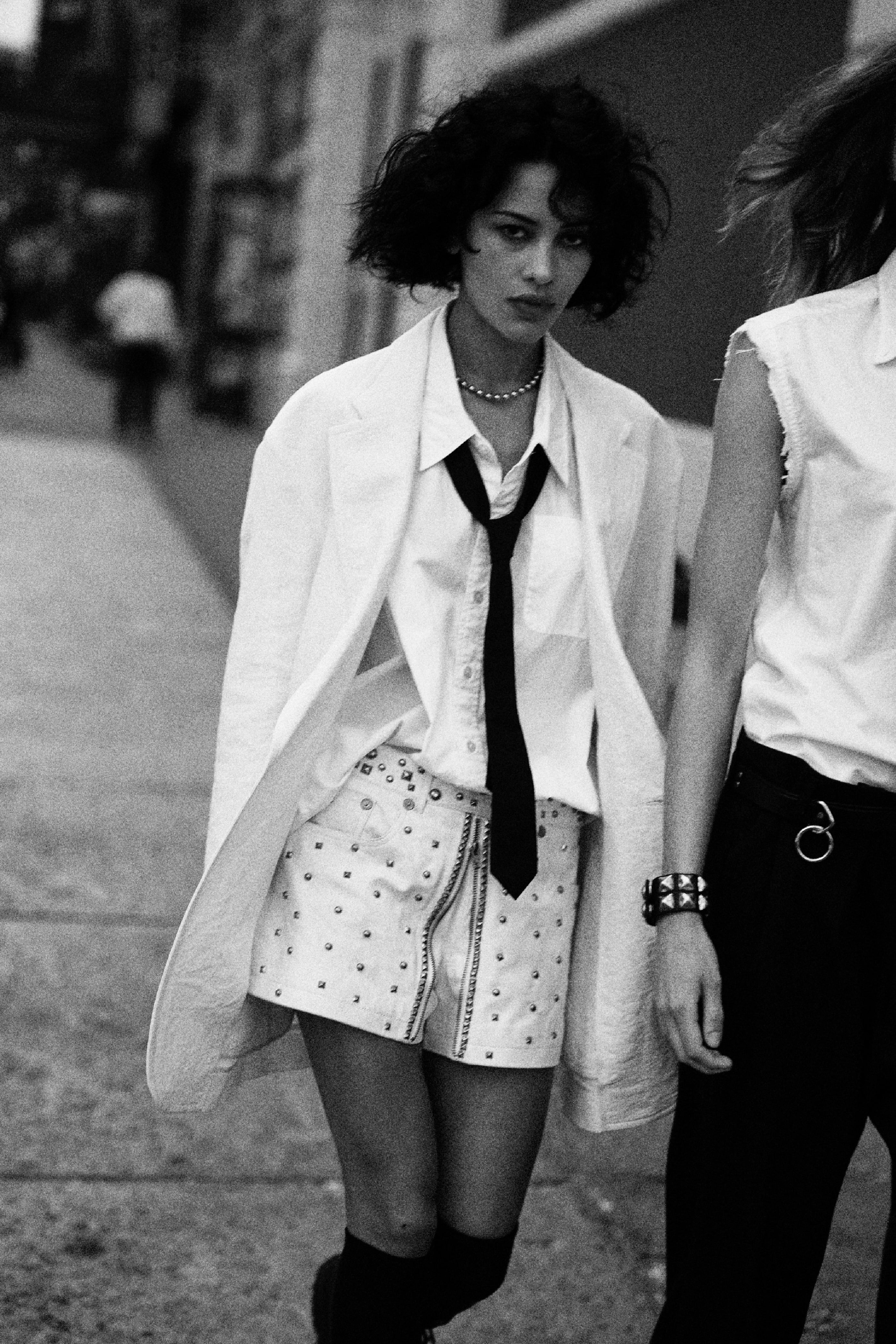 White shirt and tie with studded mini skirt and oversized blazer