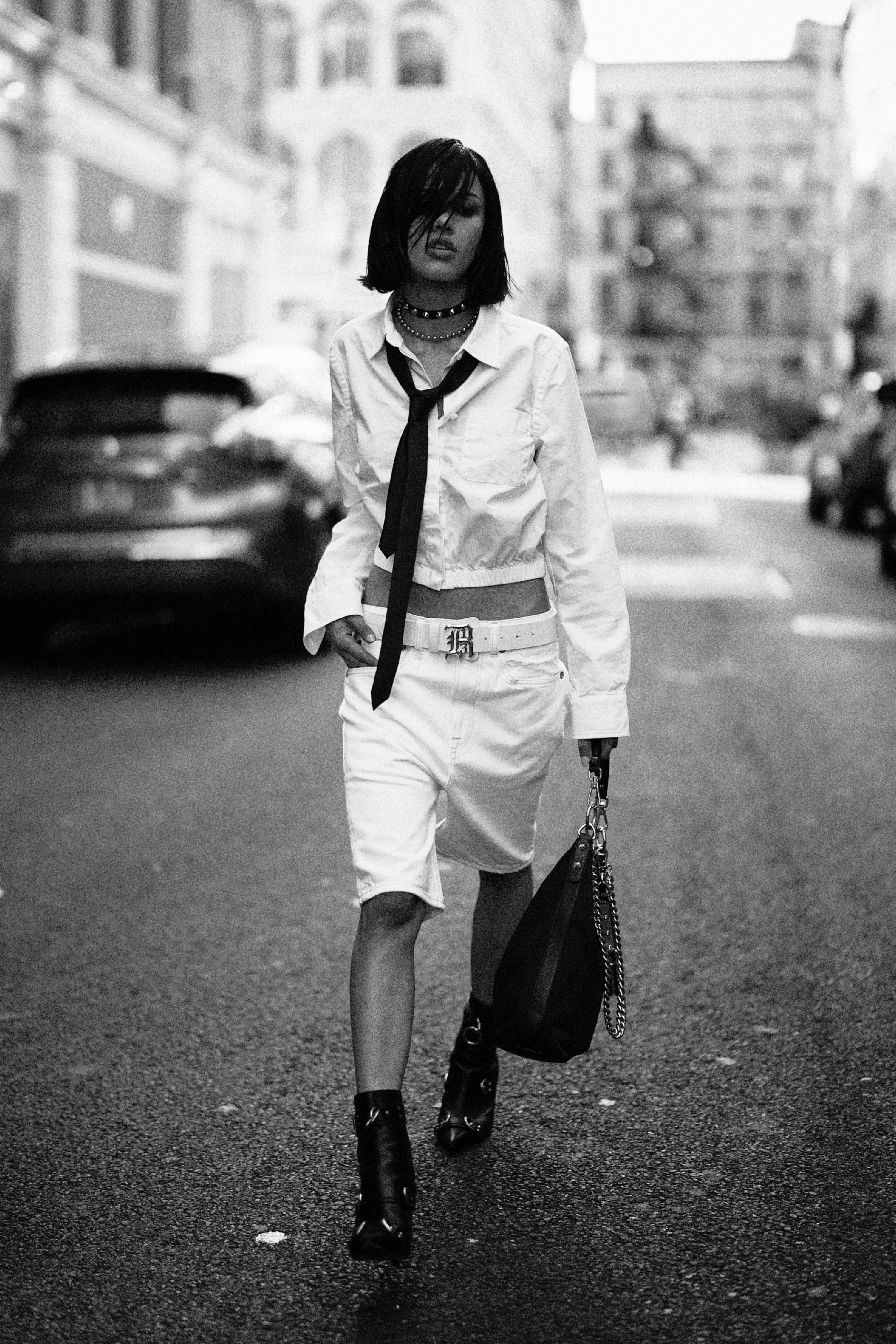 White shirt and tie paired with tailored shorts and pointed boots