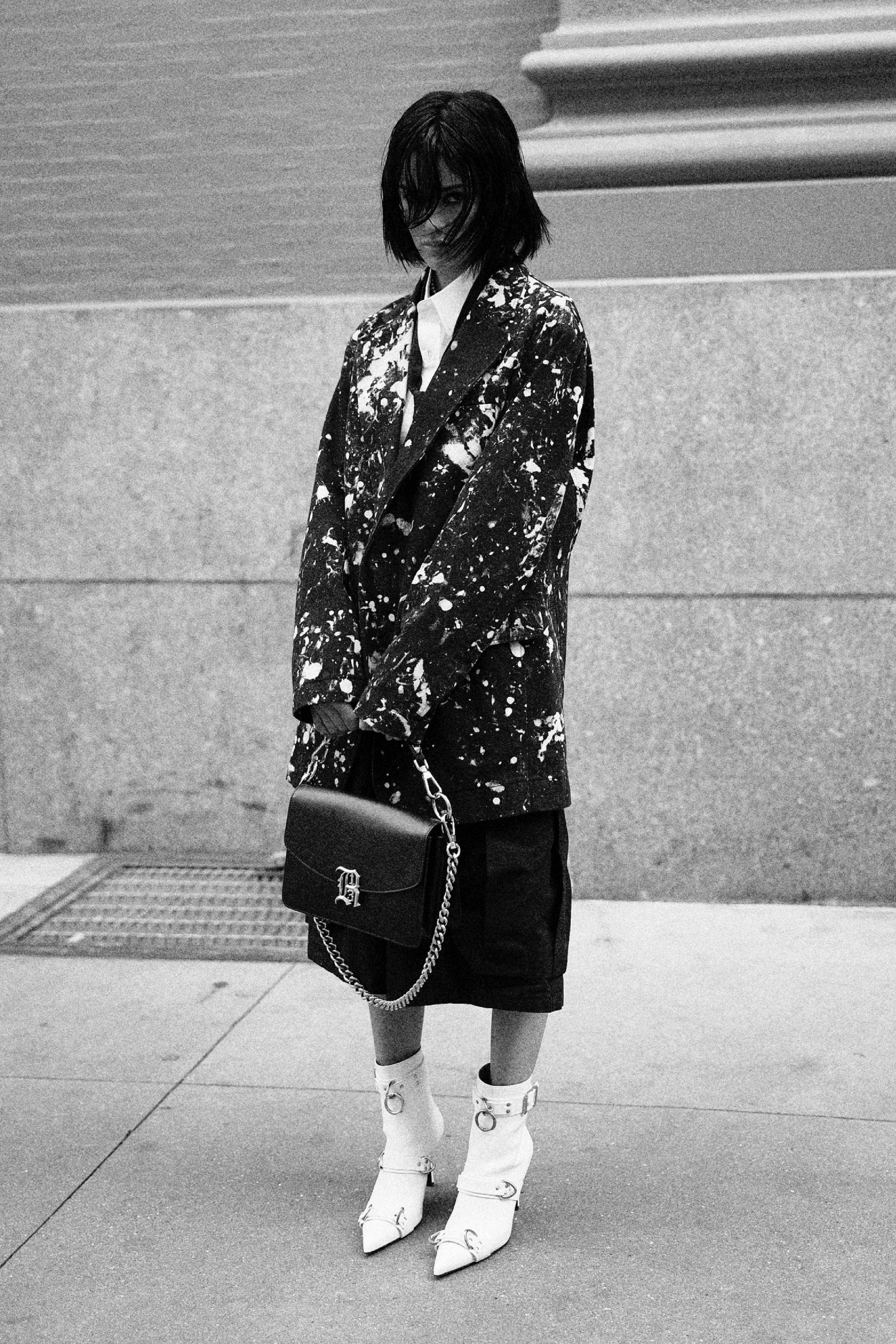 Paint splatter blazer styled with midi skirt and chain strap bag